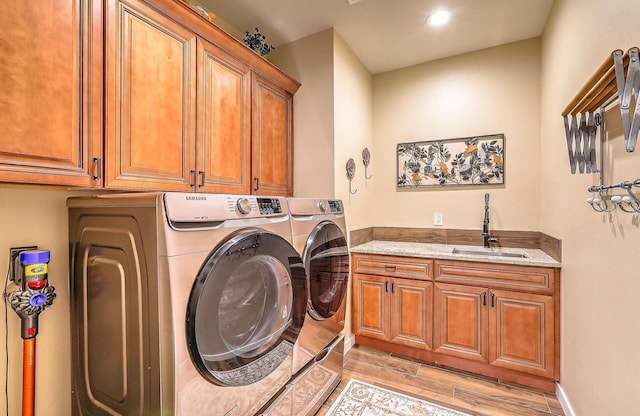 3919 Bryan Ave NW, Albuquerque, NM 87114 - washroom featuring cabinet space, washing machine and dryer, light wood-style flooring, and recessed lighting