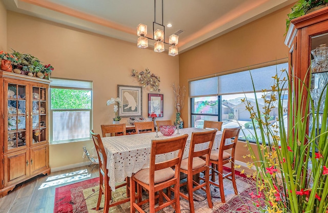 3919 Bryan Ave NW, Albuquerque, NM 87114 - dining area with wood finished floors, a chandelier, baseboards, and recessed lighting