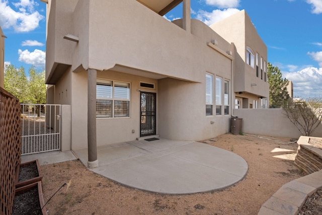 8719 Desert Fox Way NE, Albuquerque, NM 87122 - back of property with fence, a gate, a patio, and stucco siding