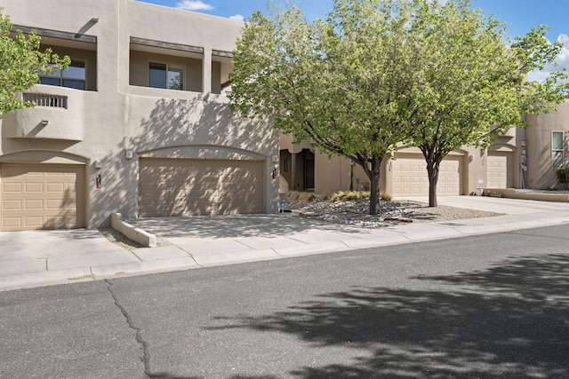 8719 Desert Fox Way NE, Albuquerque, NM 87122 - view of front facade with stucco siding and driveway