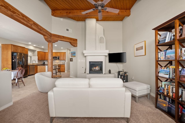 8719 Desert Fox Way NE, Albuquerque, NM 87122 - living room with ceiling fan, visible vents, a fireplace, beam ceiling, and wooden ceiling