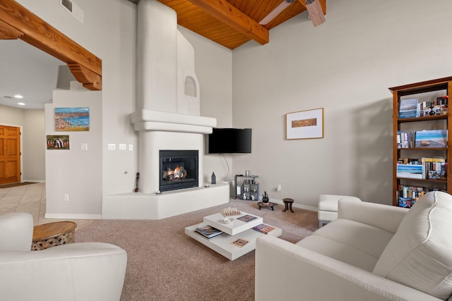 8719 Desert Fox Way NE, Albuquerque, NM 87122 - carpeted living area with baseboards, beamed ceiling, a large fireplace, and wood ceiling