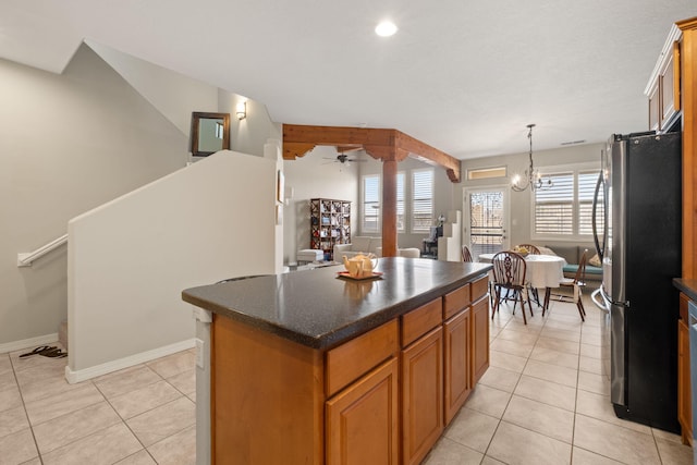 8719 Desert Fox Way NE, Albuquerque, NM 87122 - kitchen featuring freestanding refrigerator, a kitchen island, dark countertops, a ceiling fan, and light tile patterned floors