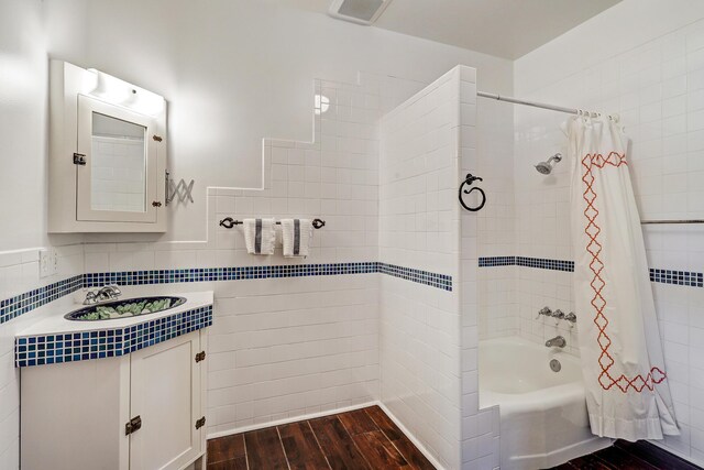107 Rome Ln, Corrales, NM 87048 - bathroom featuring tile walls, wood finished floors, shower / bath combo with shower curtain, and vanity