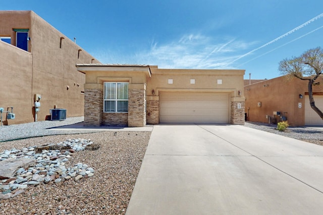 view of front of property with concrete driveway, stucco siding, stone siding, and a garage