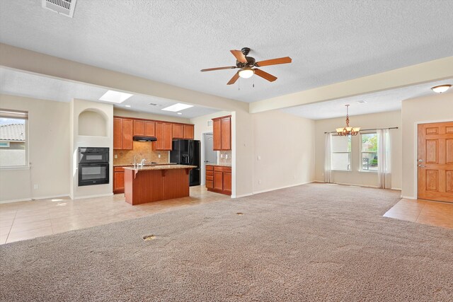 1047 Prairie Zinnia Dr, Bernalillo, NM 87004 - kitchen with open floor plan, black appliances, light tile patterned floors, ceiling fan, and light colored carpet