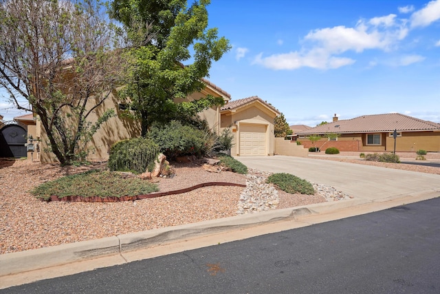 1047 Prairie Zinnia Dr, Bernalillo, NM 87004 - view of front facade featuring driveway, a garage, stucco siding, and a tile roof