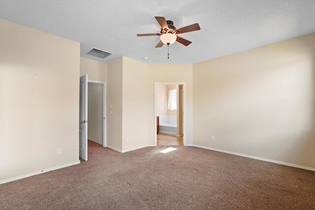 1047 Prairie Zinnia Dr, Bernalillo, NM 87004 - spare room featuring carpet flooring, a ceiling fan, a textured ceiling, and baseboards