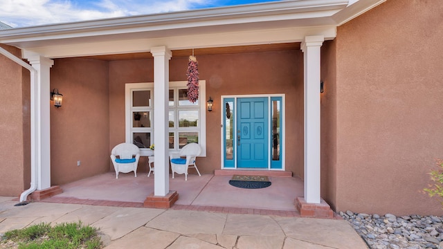 535 Cacahuate SW, Albuquerque, NM 87105 - property entrance with stucco siding and a porch