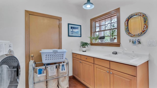 535 Cacahuate SW, Albuquerque, NM 87105 - bathroom with washer / dryer, vanity, and wood finished floors