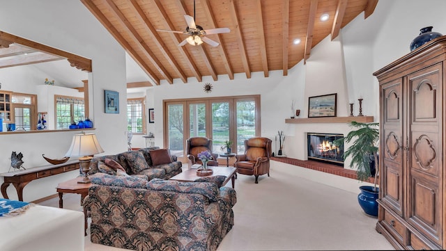 535 Cacahuate SW, Albuquerque, NM 87105 - carpeted living area featuring wooden ceiling, beam ceiling, ceiling fan, a large fireplace, and high vaulted ceiling