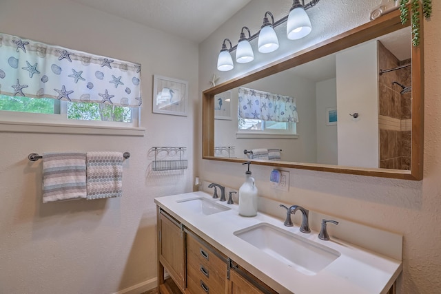 full bathroom with a sink and double vanity