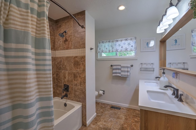 full bath featuring a sink, shower / tub combo with curtain, toilet, baseboards, and visible vents