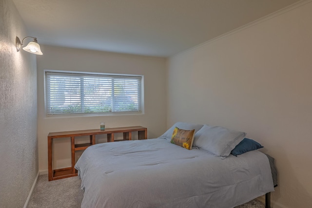 carpeted bedroom with baseboards and ornamental molding