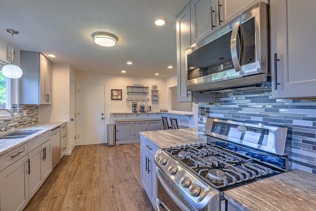 kitchen featuring recessed lighting, a sink, appliances with stainless steel finishes, and backsplash