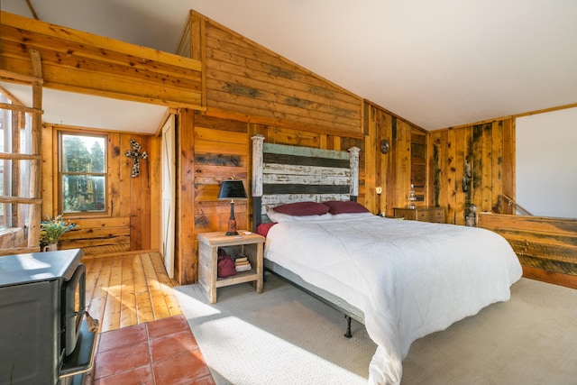 bedroom with wood walls and vaulted ceiling