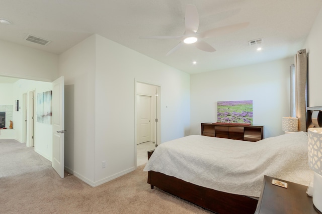 bedroom featuring visible vents, a ceiling fan, baseboards, and light carpet