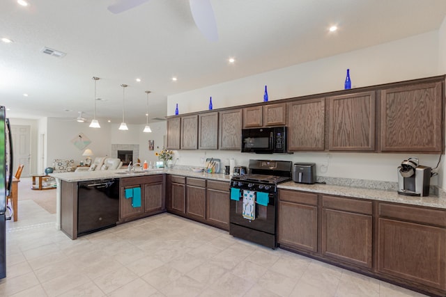 kitchen featuring visible vents, a sink, black appliances, a peninsula, and open floor plan