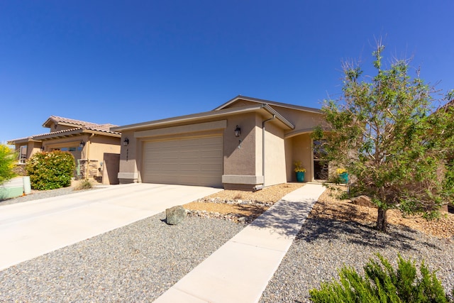 ranch-style house with concrete driveway, stucco siding, and an attached garage