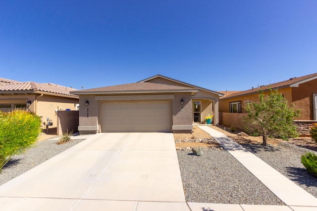 ranch-style house with a garage, stucco siding, fence, and concrete driveway