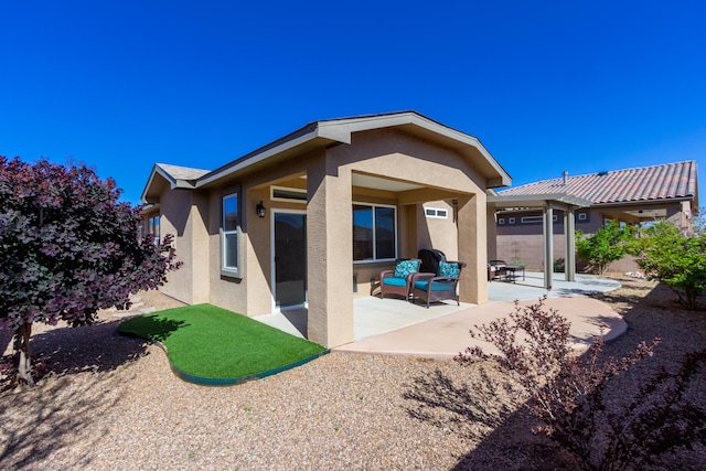 rear view of property featuring a patio area, stucco siding, and fence