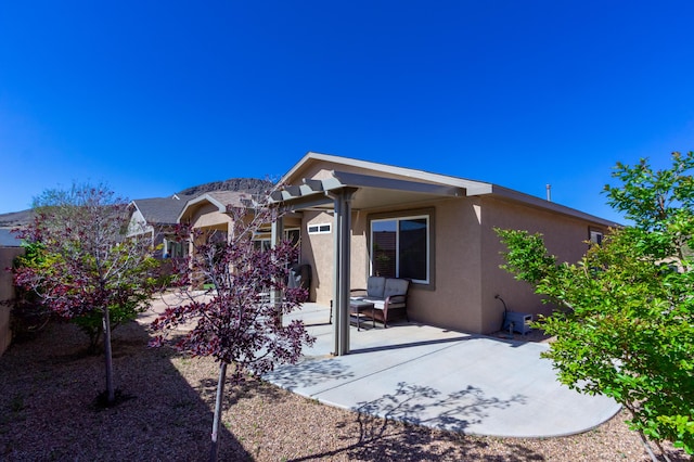 back of house with a patio area and stucco siding