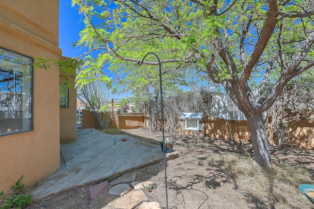 view of yard featuring a fenced backyard and a deck
