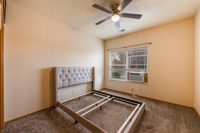 unfurnished bedroom with a ceiling fan, carpet flooring, cooling unit, and visible vents