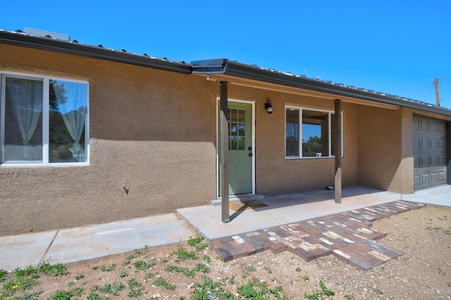 doorway to property with stucco siding