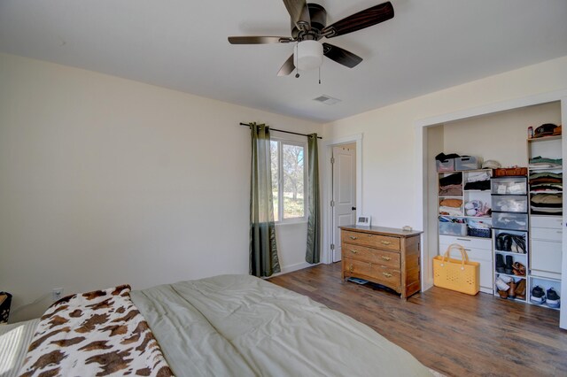 bedroom featuring visible vents, ceiling fan, and wood finished floors