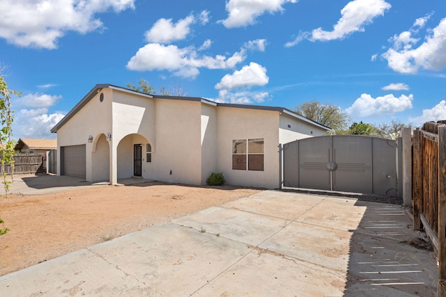 5812 Alegria Rd NW, Albuquerque, NM 87114 - rear view of house featuring fence, stucco siding, and driveway