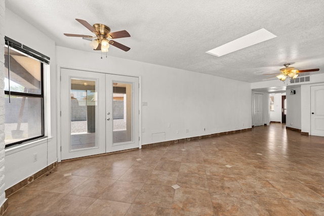 5812 Alegria Rd NW, Albuquerque, NM 87114 - unfurnished living room with french doors, a skylight, a ceiling fan, and visible vents