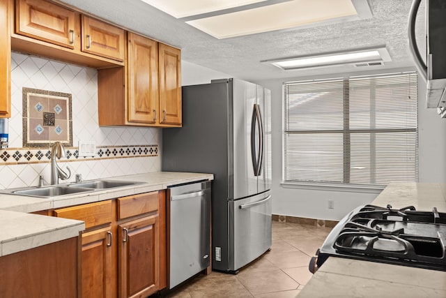 5812 Alegria Rd NW, Albuquerque, NM 87114 - kitchen with a sink, decorative backsplash, appliances with stainless steel finishes, and light countertops