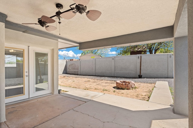 5812 Alegria Rd NW, Albuquerque, NM 87114 - view of patio / terrace featuring fence, ceiling fan, and an outdoor fire pit