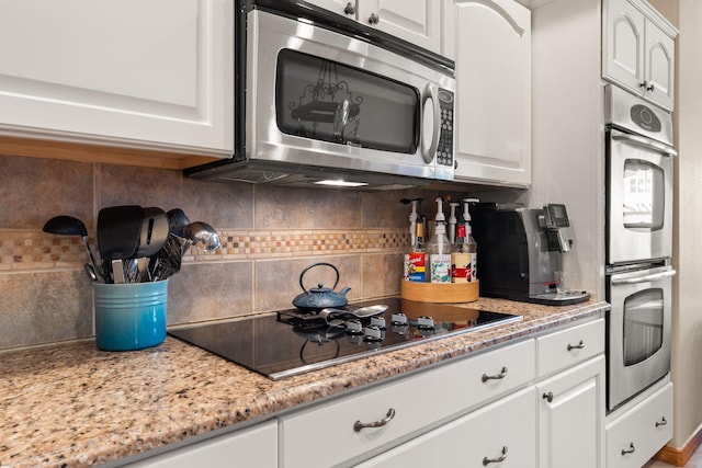 3809 Bay Hill Loop SE, Rio Rancho, NM 87124 - kitchen featuring light stone counters, tasteful backsplash, stainless steel appliances, and white cabinetry