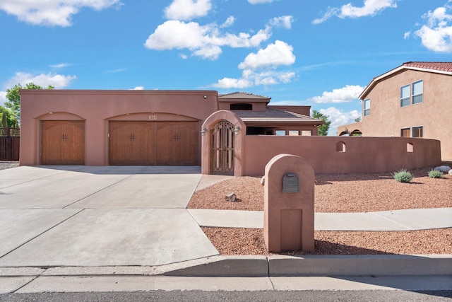 3809 Bay Hill Loop SE, Rio Rancho, NM 87124 - adobe home with a tiled roof, a fenced front yard, concrete driveway, an attached garage, and stucco siding