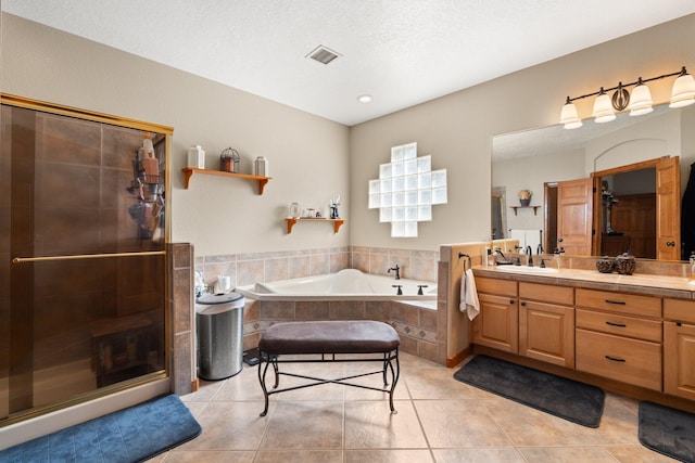 3809 Bay Hill Loop SE, Rio Rancho, NM 87124 - bathroom featuring visible vents, vanity, a bath, tile patterned floors, and a stall shower