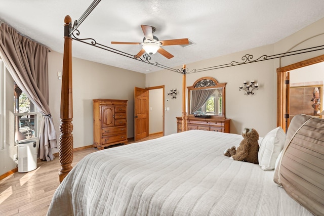 3809 Bay Hill Loop SE, Rio Rancho, NM 87124 - bedroom with a ceiling fan, baseboards, a textured ceiling, and light wood-type flooring