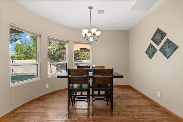 3809 Bay Hill Loop SE, Rio Rancho, NM 87124 - dining space with baseboards, an inviting chandelier, visible vents, and hardwood / wood-style floors