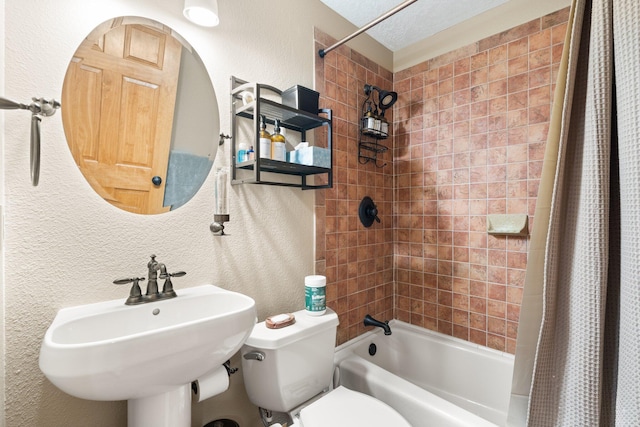 3809 Bay Hill Loop SE, Rio Rancho, NM 87124 - bathroom featuring shower / bath combo with shower curtain, a sink, a textured wall, and toilet