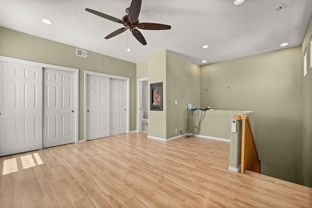 interior space featuring a ceiling fan, visible vents, light wood-type flooring, baseboards, and recessed lighting