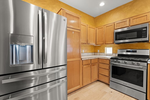 kitchen with recessed lighting, appliances with stainless steel finishes, and light wood-type flooring