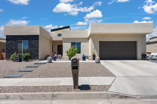 southwest-style home with an attached garage, stucco siding, and concrete driveway