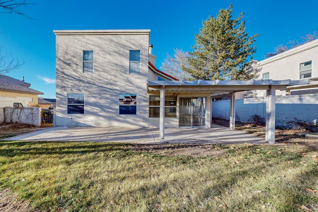 rear view of house with a lawn, a patio area, and fence private yard