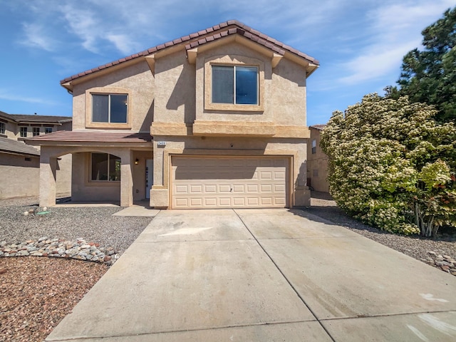view of front of home featuring a garage, stucco siding, a tile roof, and concrete driveway