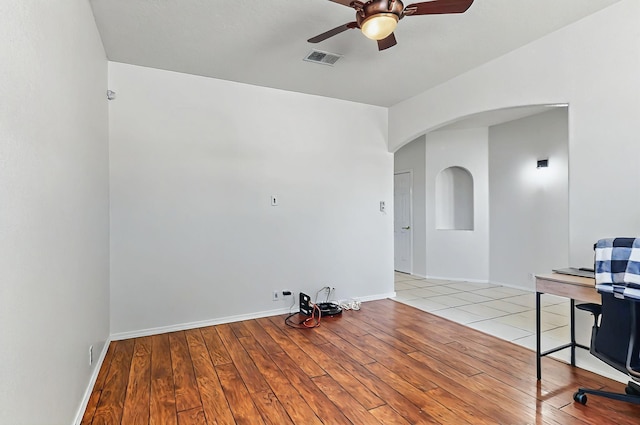 4954 Dream Dancer Dr NE, Rio Rancho, NM 87144 - unfurnished room with arched walkways, a ceiling fan, light wood-style flooring, and visible vents