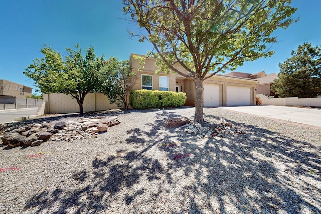 4954 Dream Dancer Dr NE, Rio Rancho, NM 87144 - view of front of property featuring an attached garage, fence, stucco siding, and concrete driveway