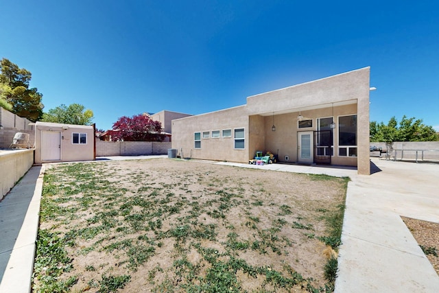 4954 Dream Dancer Dr NE, Rio Rancho, NM 87144 - rear view of property with a patio, a fenced backyard, stucco siding, and an outdoor structure