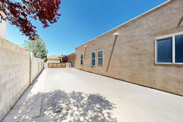 4954 Dream Dancer Dr NE, Rio Rancho, NM 87144 - view of home's exterior featuring a fenced backyard, a patio area, and stucco siding
