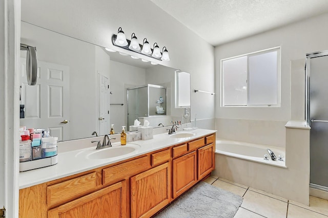 4954 Dream Dancer Dr NE, Rio Rancho, NM 87144 - full bathroom featuring tile patterned flooring, double vanity, a bath, a sink, and a stall shower